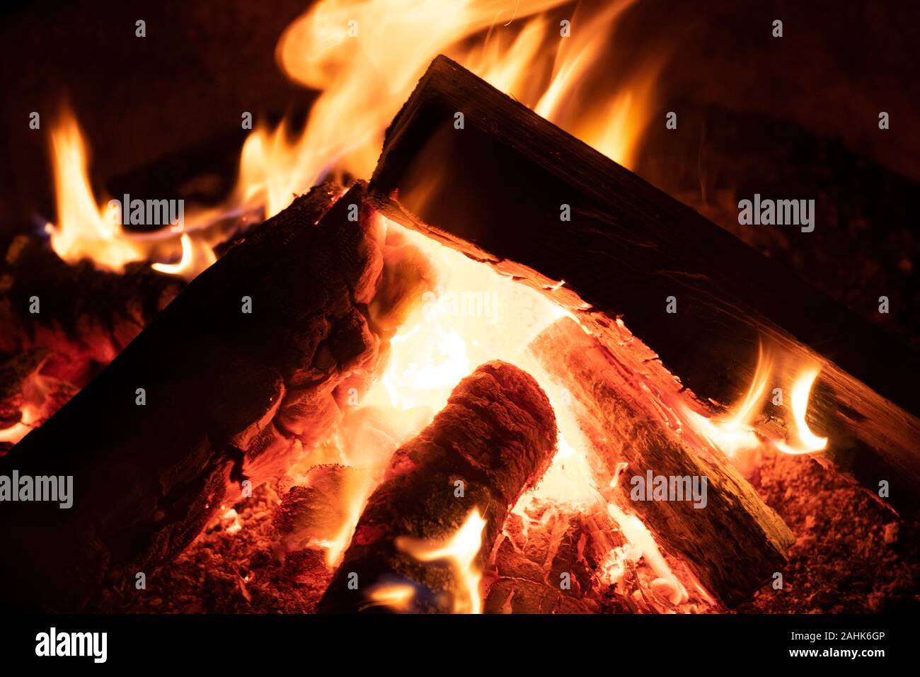 A glowing camp fire providing comfort and light during a cool summer