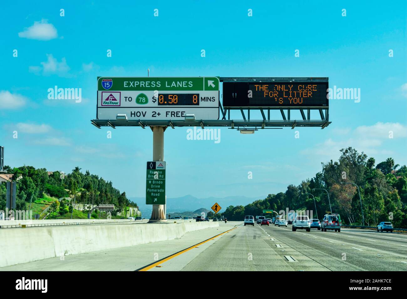 Express lanes marked by overhead signage, and smaller HOV sign located in the median on highway. The toll amount is posted on an electric changeable b Stock Photo