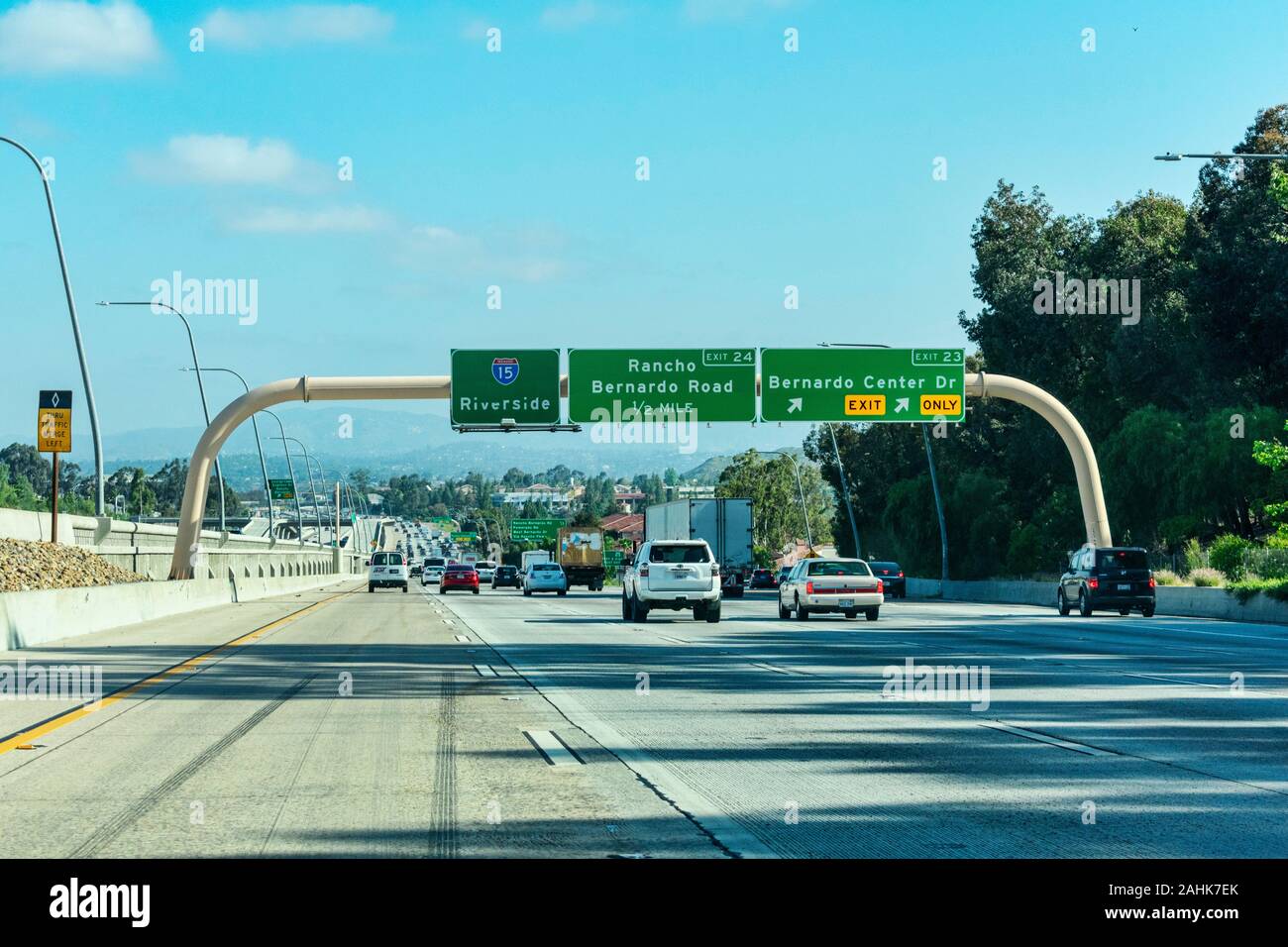 Guide signs on large overhead signage informing drivers about the intersections and highways, and distance and directions to destinations - Riverside, Stock Photo