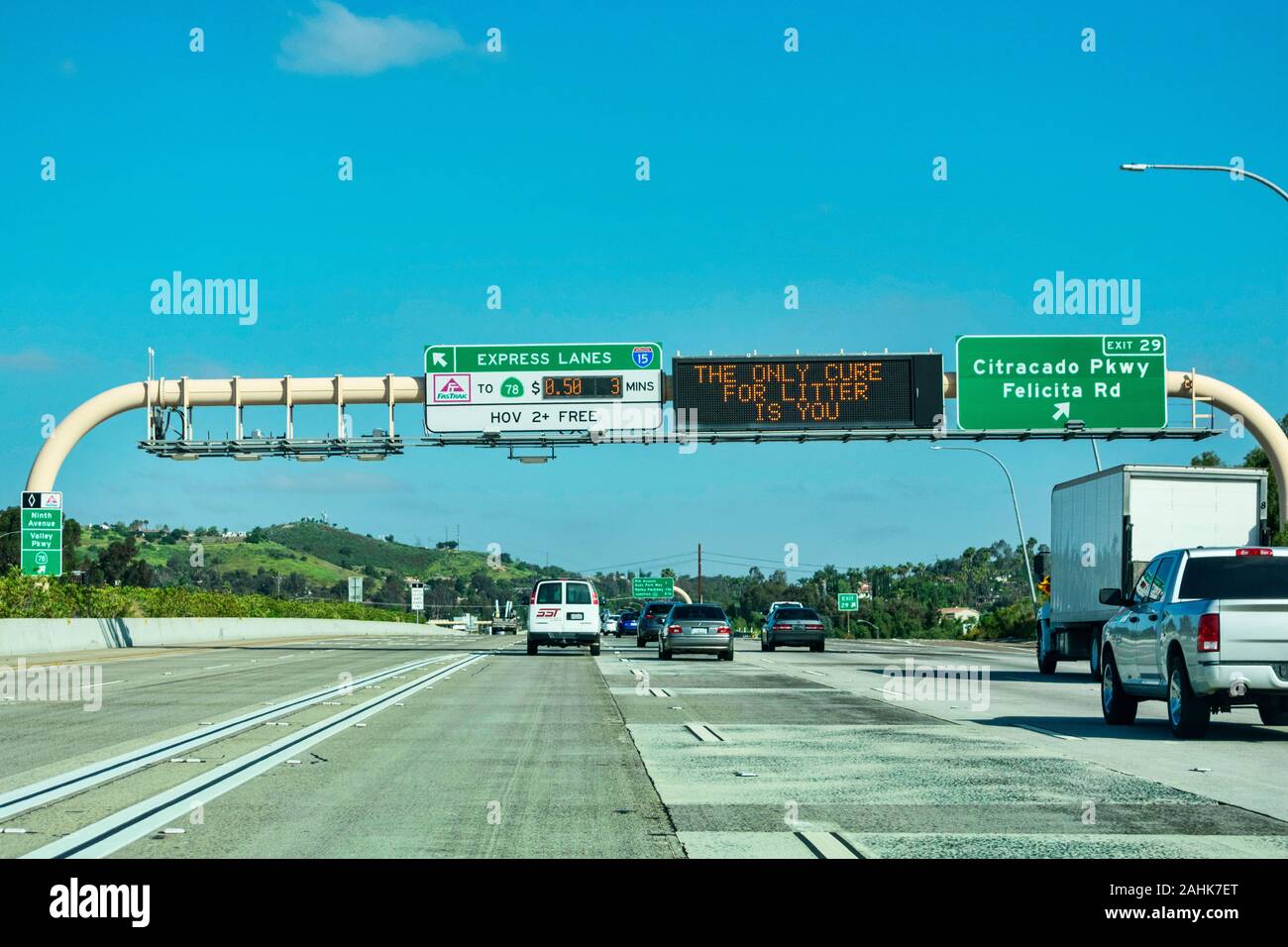 Express lanes marked by large overhead signage with toll amount. The only cure for litter is you text on the electronic variable message sign - San Di Stock Photo