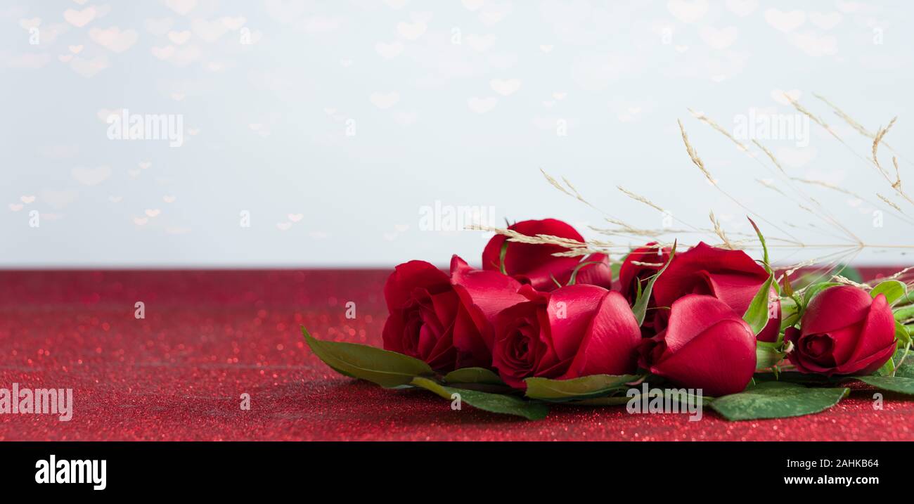 roses on shiny red texture Stock Photo