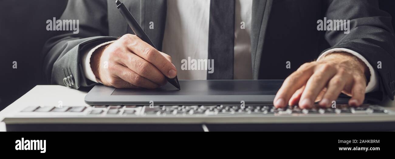 Wide view image of businessman or graphic designer using a stylus pen ...