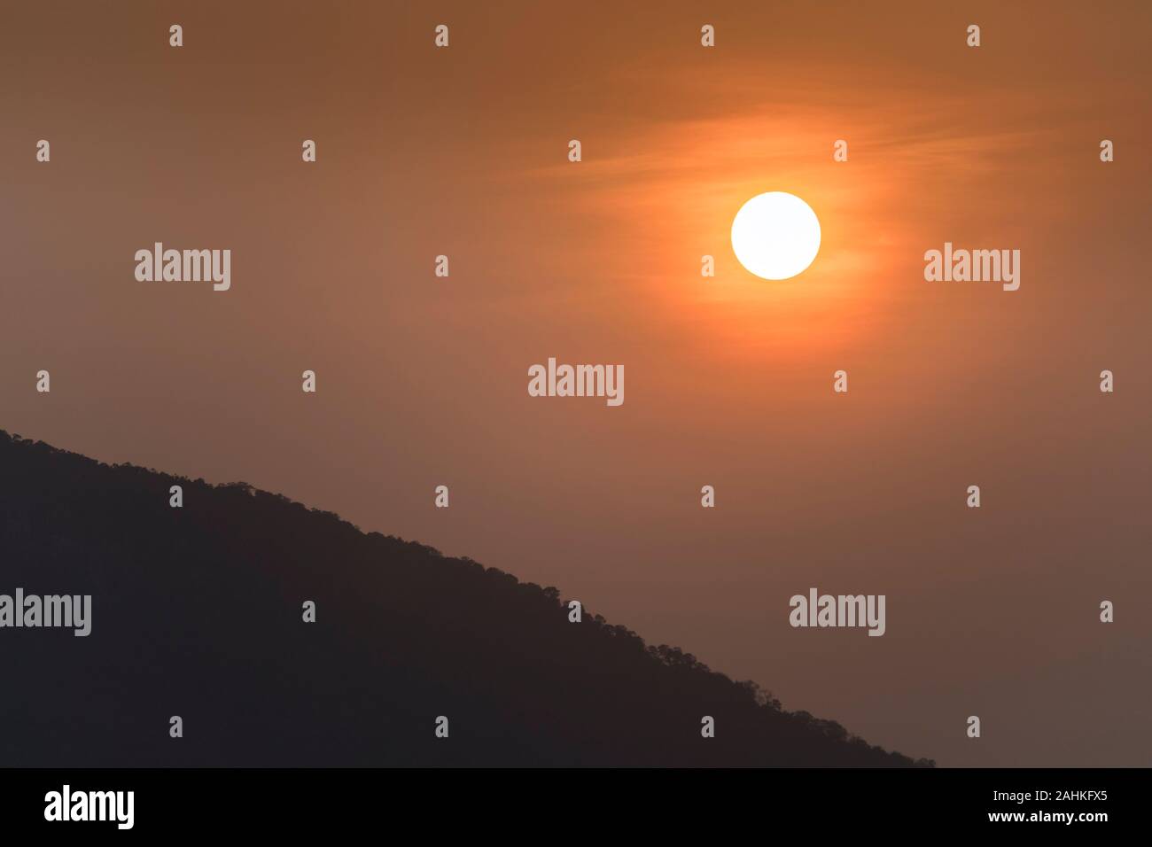 Sunset over trees, Laos Stock Photo