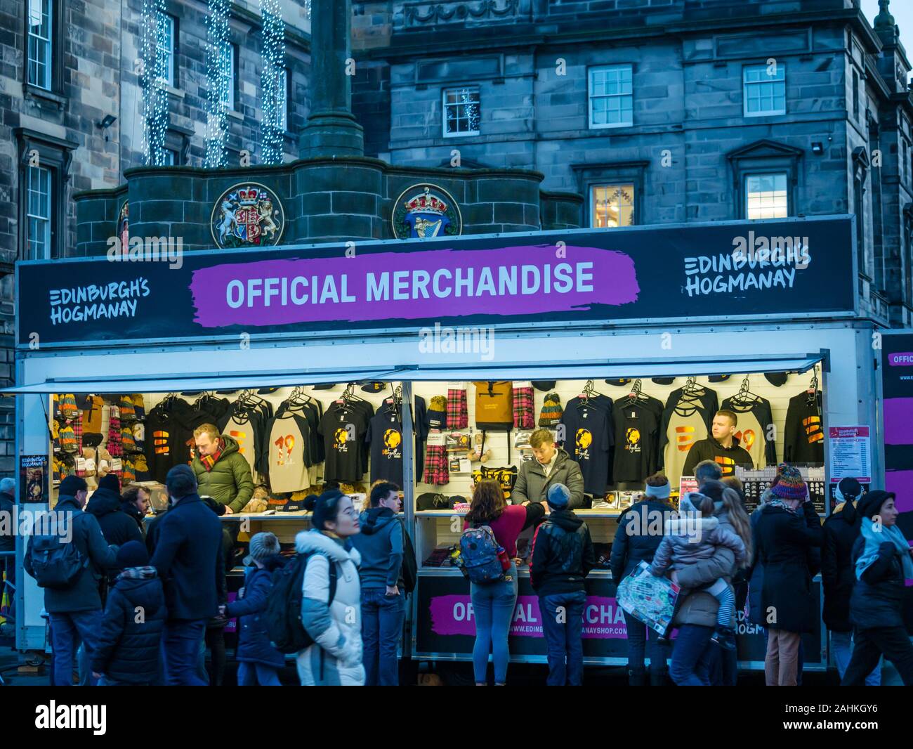 People buying merchandise for Edinburgh Hogmanay at street stall selling official goods, Royal Mile, Edinburgh, Scotland, UK Stock Photo