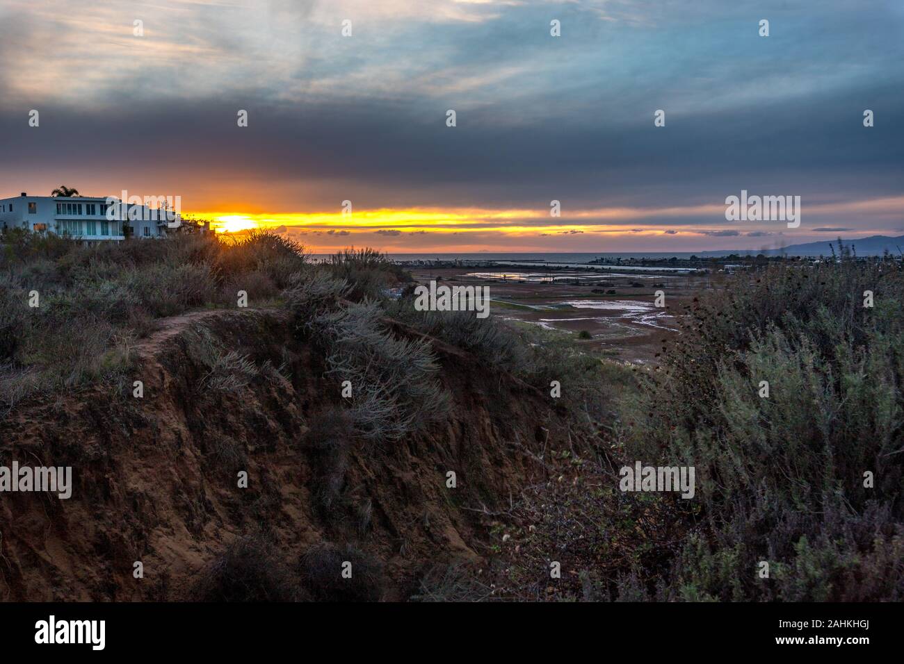 Long exposure bluff top view of Ballona Wetlands at sunset with colorful sky and Santa Monica Mountains in the distance, Playa Del Rey, California Stock Photo