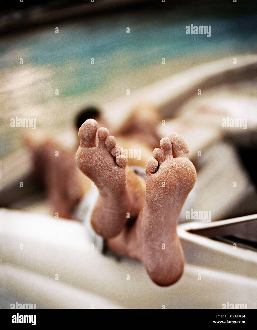 Soles of dusty feet are seen. Stock Photo