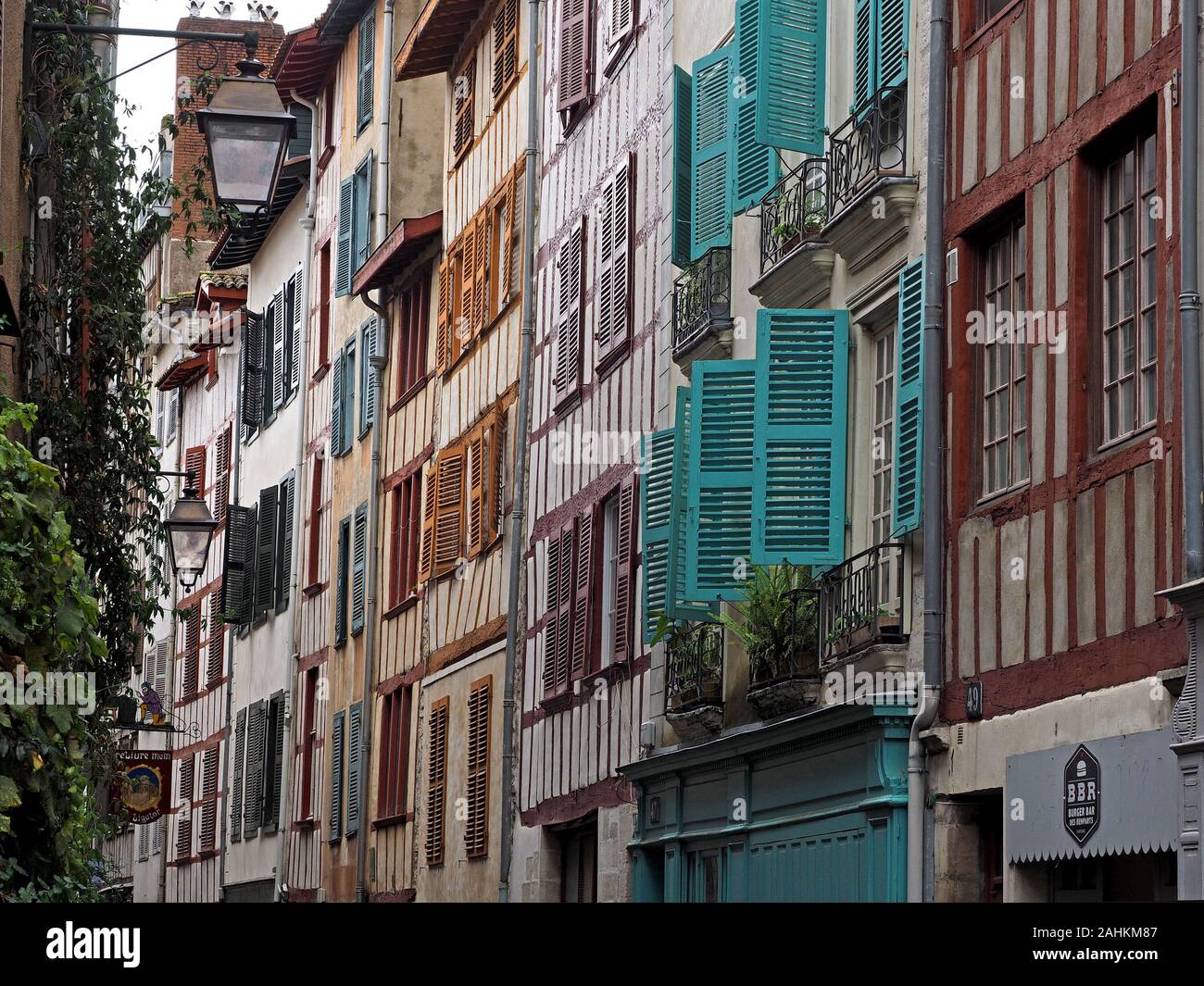 vernacular buildings in the streets of the city of Bayonne, with typical wooden shuttered windows, timbered facades and bronze lanterns  France,Europe Stock Photo