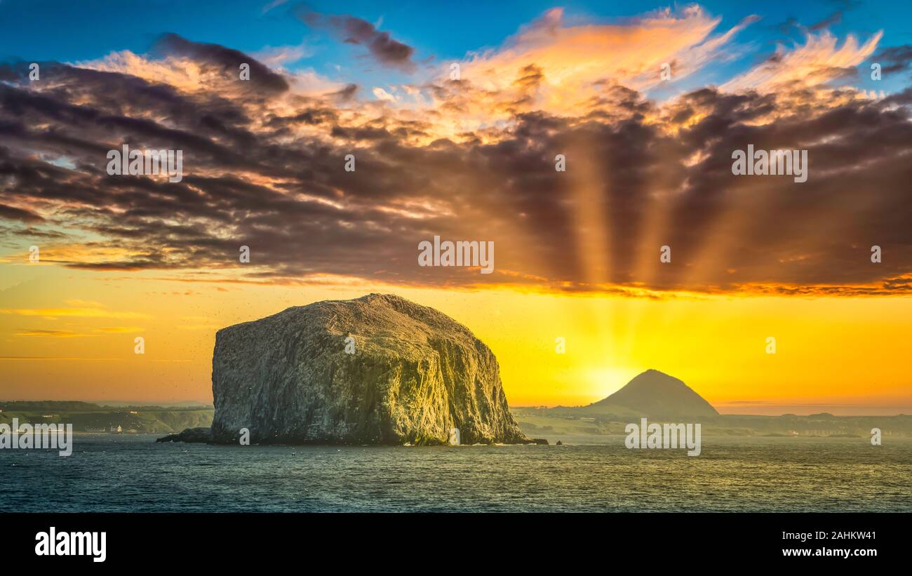A bird rock in the North Atlantic Ocean at sunset. Stock Photo