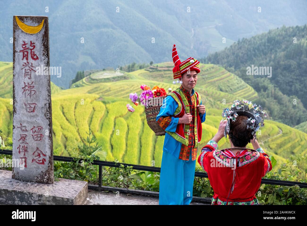 Chinese tourists wear National costumes at the Longji Rice terraces, Guangxi, China Stock Photo
