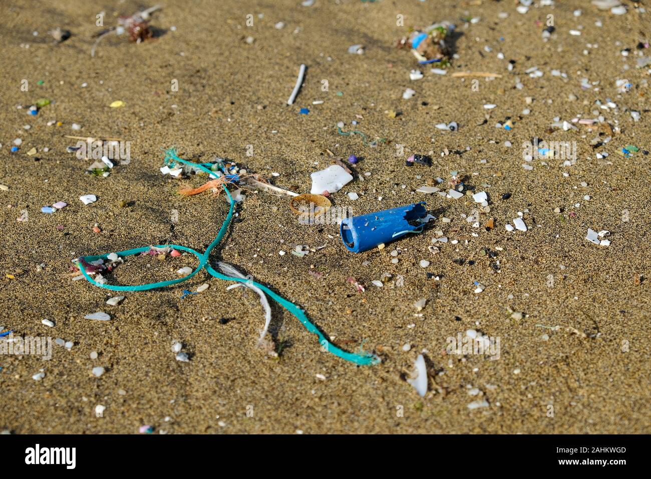 Plastic debris and microplastics pollution on the shore. Stock Photo