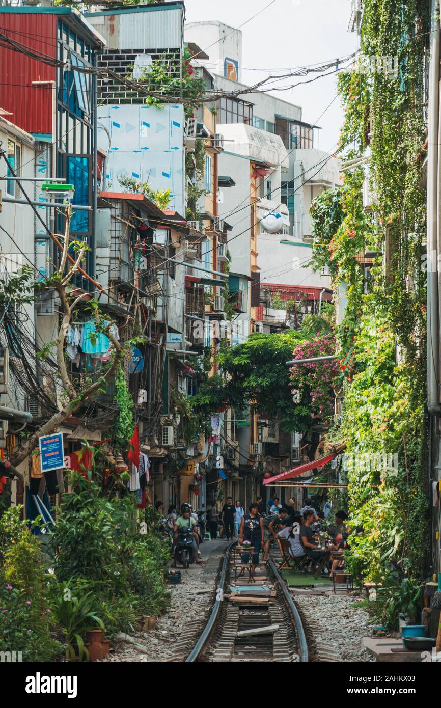 Tourists enjoy outdoor cafe seating on the tracks in Hanoi's infamous