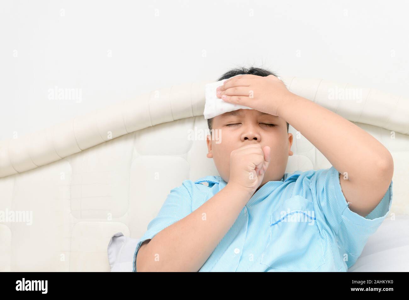 Sick child with high fever and coughs on bed, Health care concept Stock