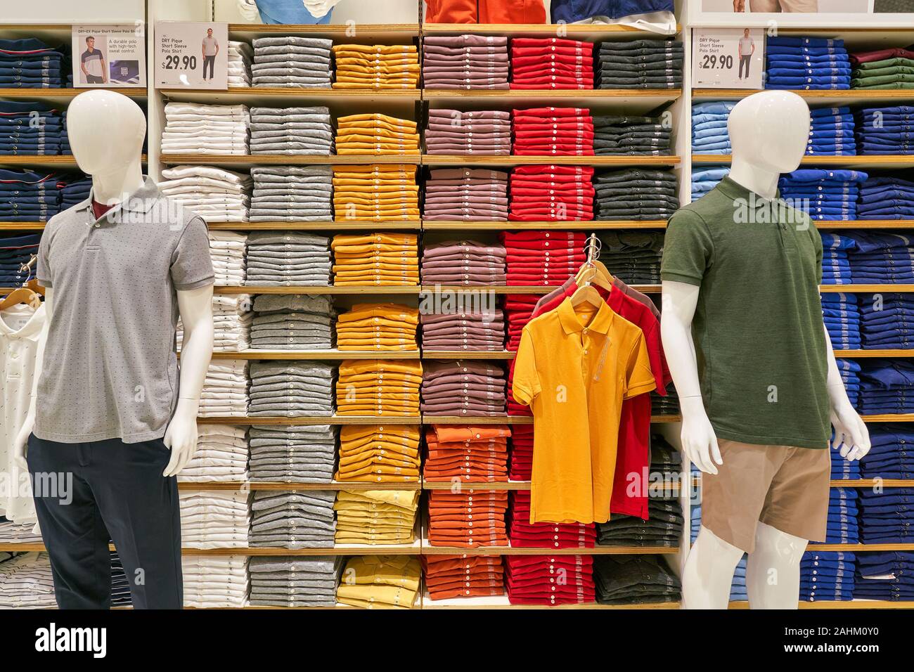 SINGAPORE - APRIL 03, 2019: clothes on display at Uniqlo store in Singapore.  Uniqlo is a Japanese casual wear designer, manufacturer and retailer Stock  Photo - Alamy
