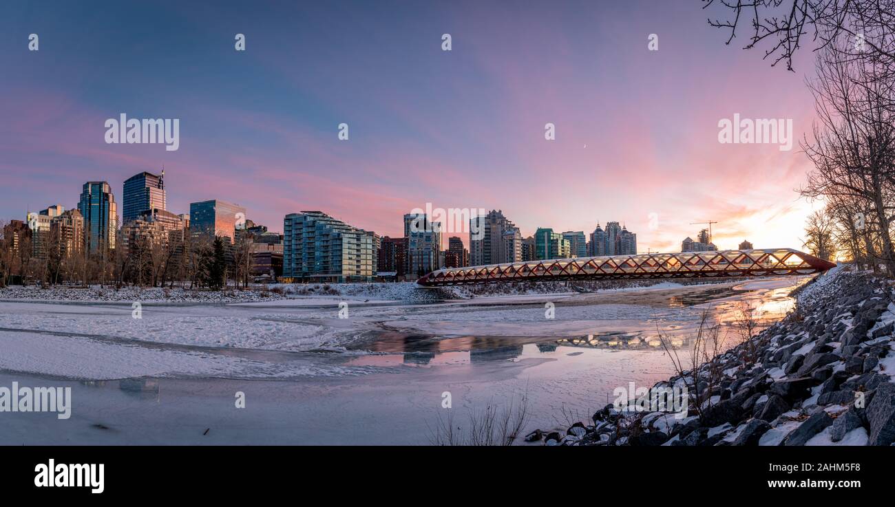 View of Calgary's skyline on a cold winter day. Bow River and the Peace Bridge are visible in the image.  Office towers in the downtown core are also. Stock Photo