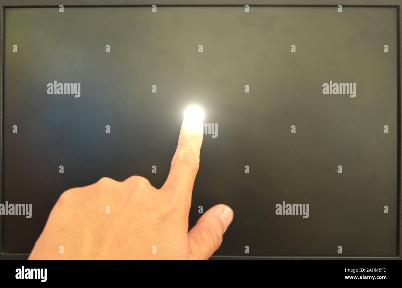 human finger touching on black computer screen and light on Stock Photo ...