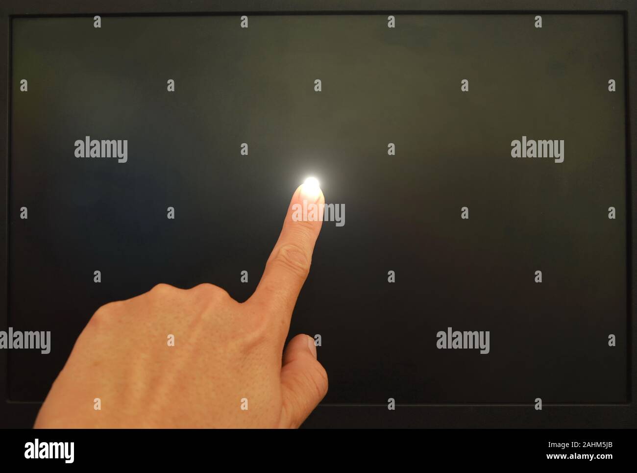 human finger touching on black computer screen and light on Stock Photo ...
