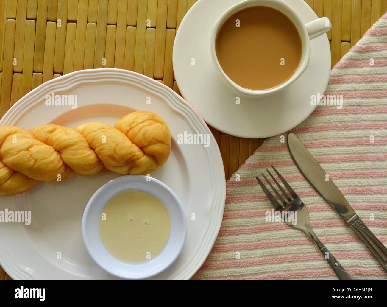 twist bread dipping with sweetened condensed milk and coffee cup Stock