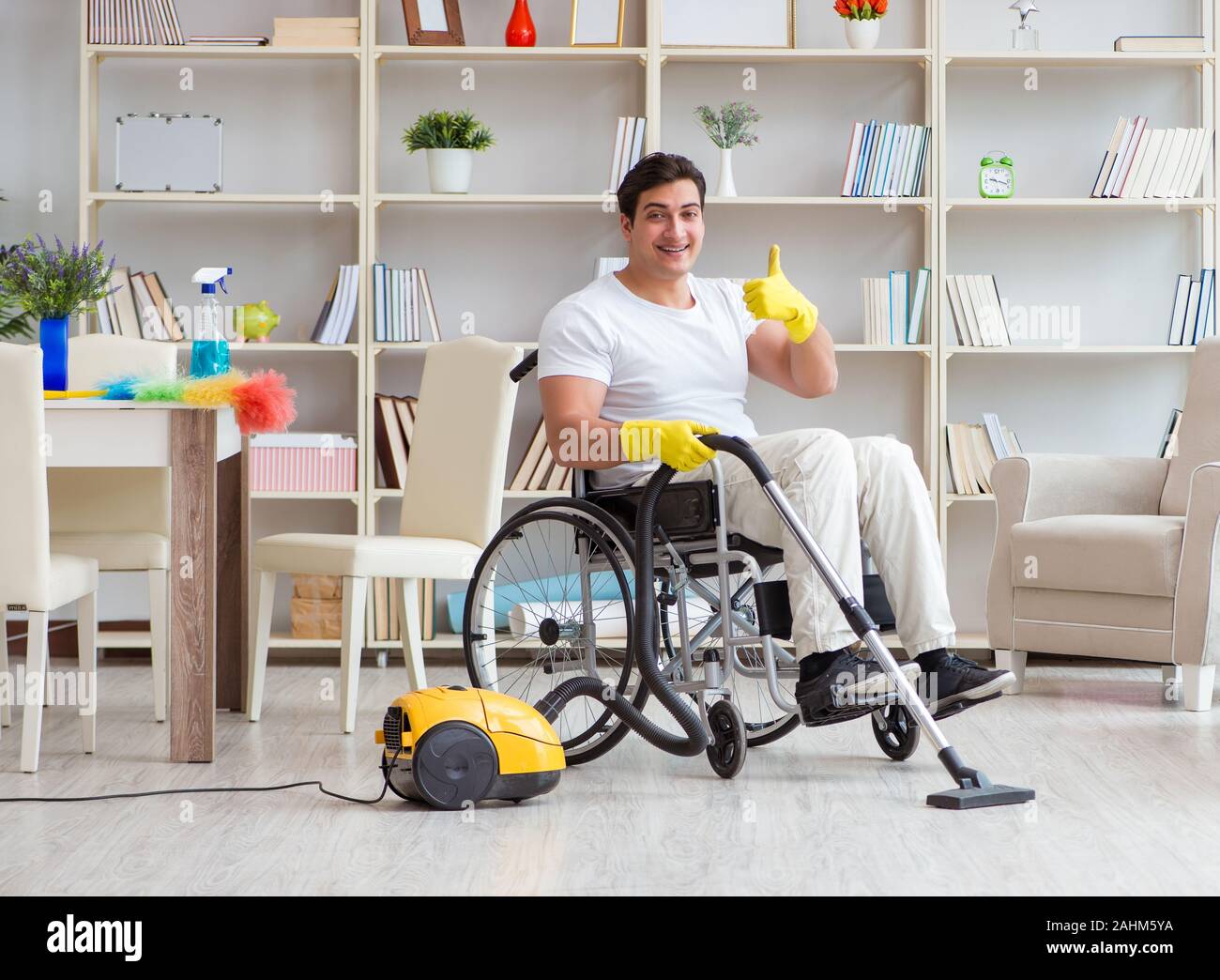 The disabled man with vacuum cleaner at home Stock Photo Alamy