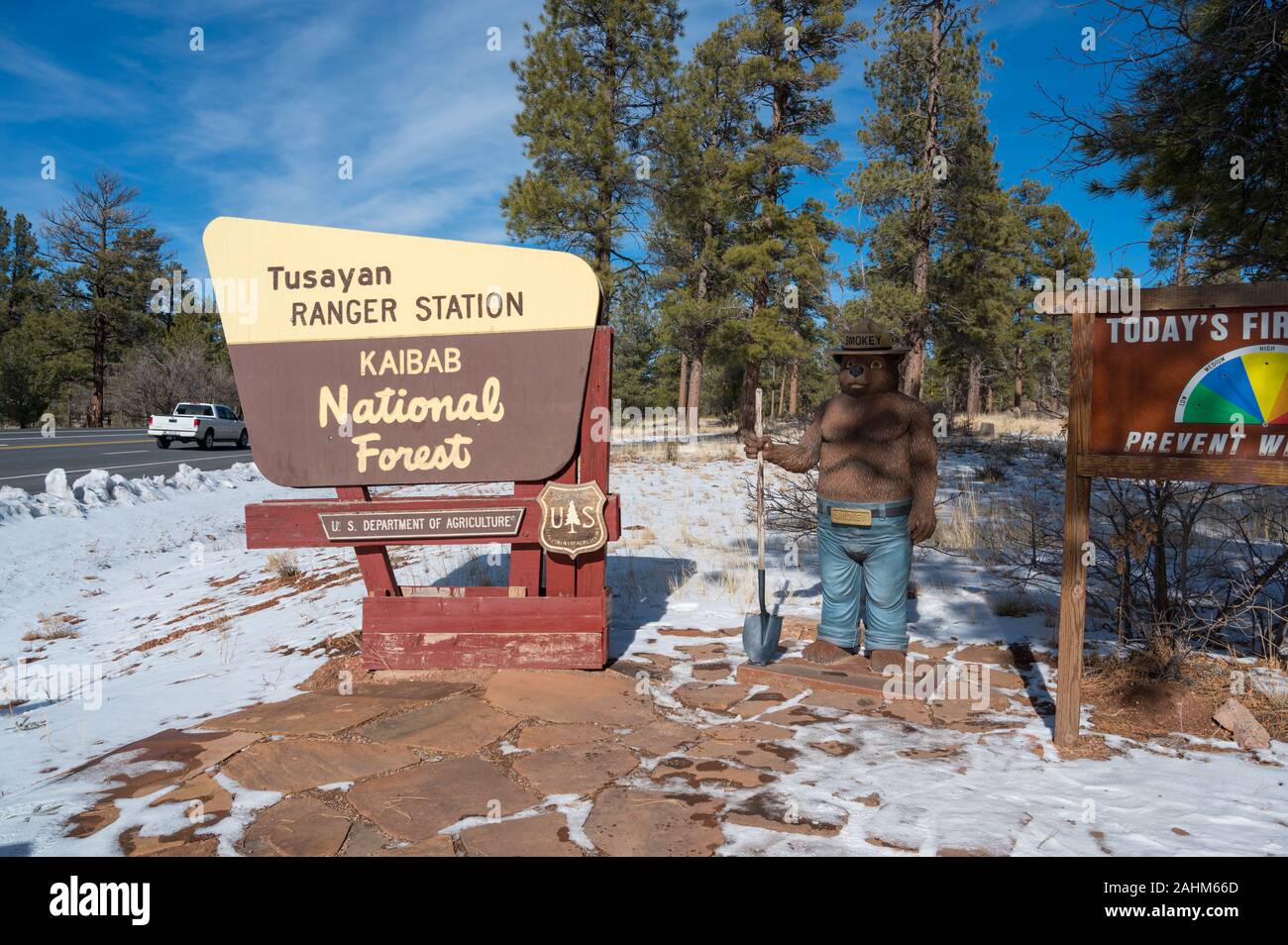 Smokey bear statue next to a sign for the Kaibab national forest Stock