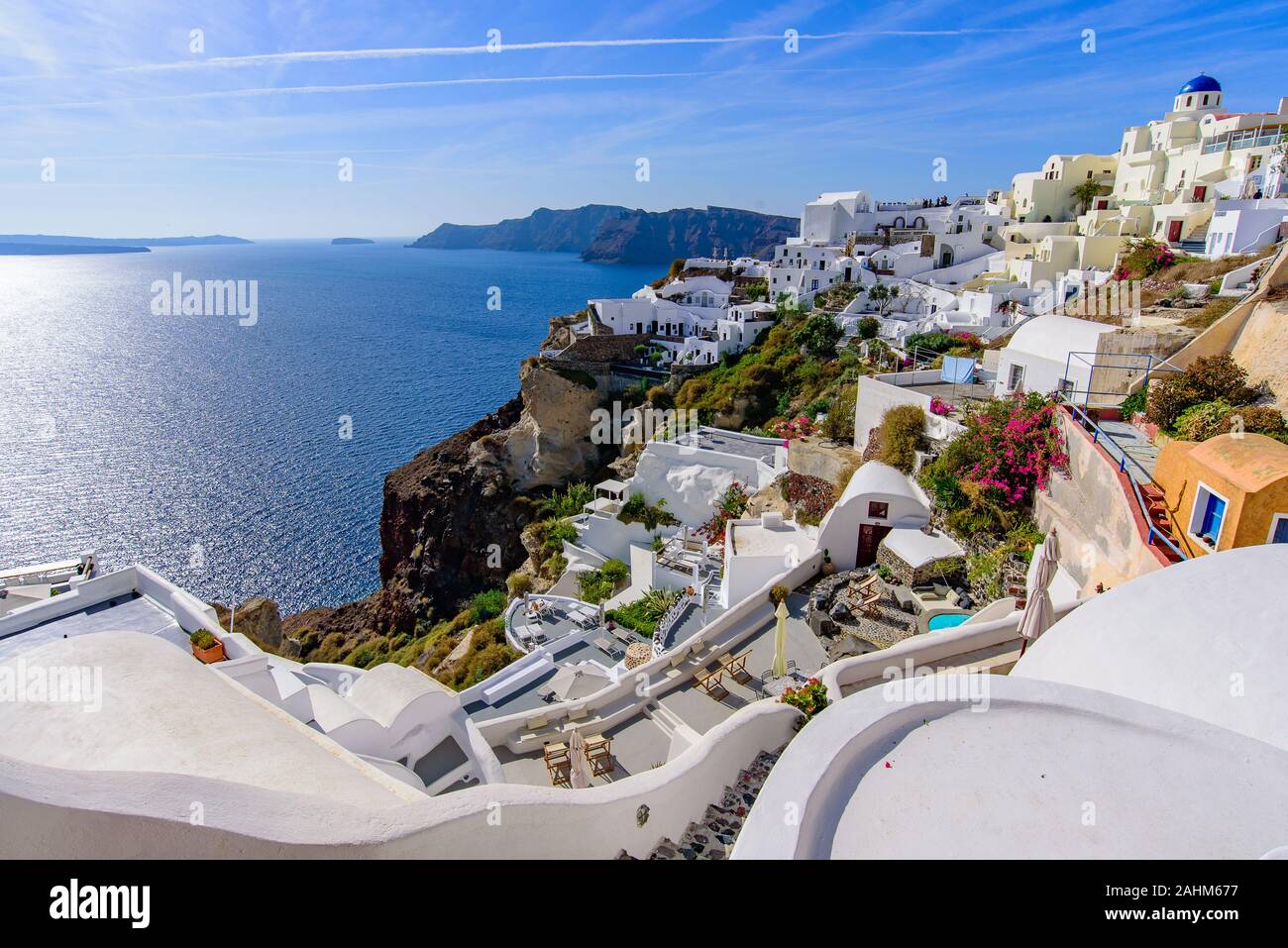 Traditional white buildings facing Mediterranean Sea in Oia, Santorini island, Greece Stock Photo