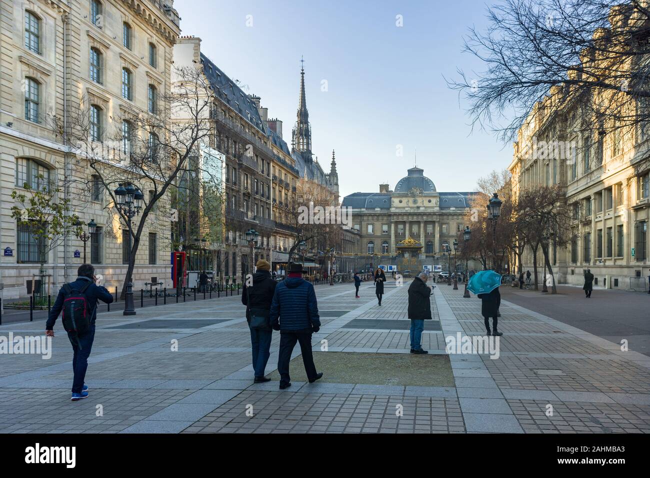 Palais de Justice de Paris viewed from Place Louis Lépine with people walking, Paris, France Stock Photo