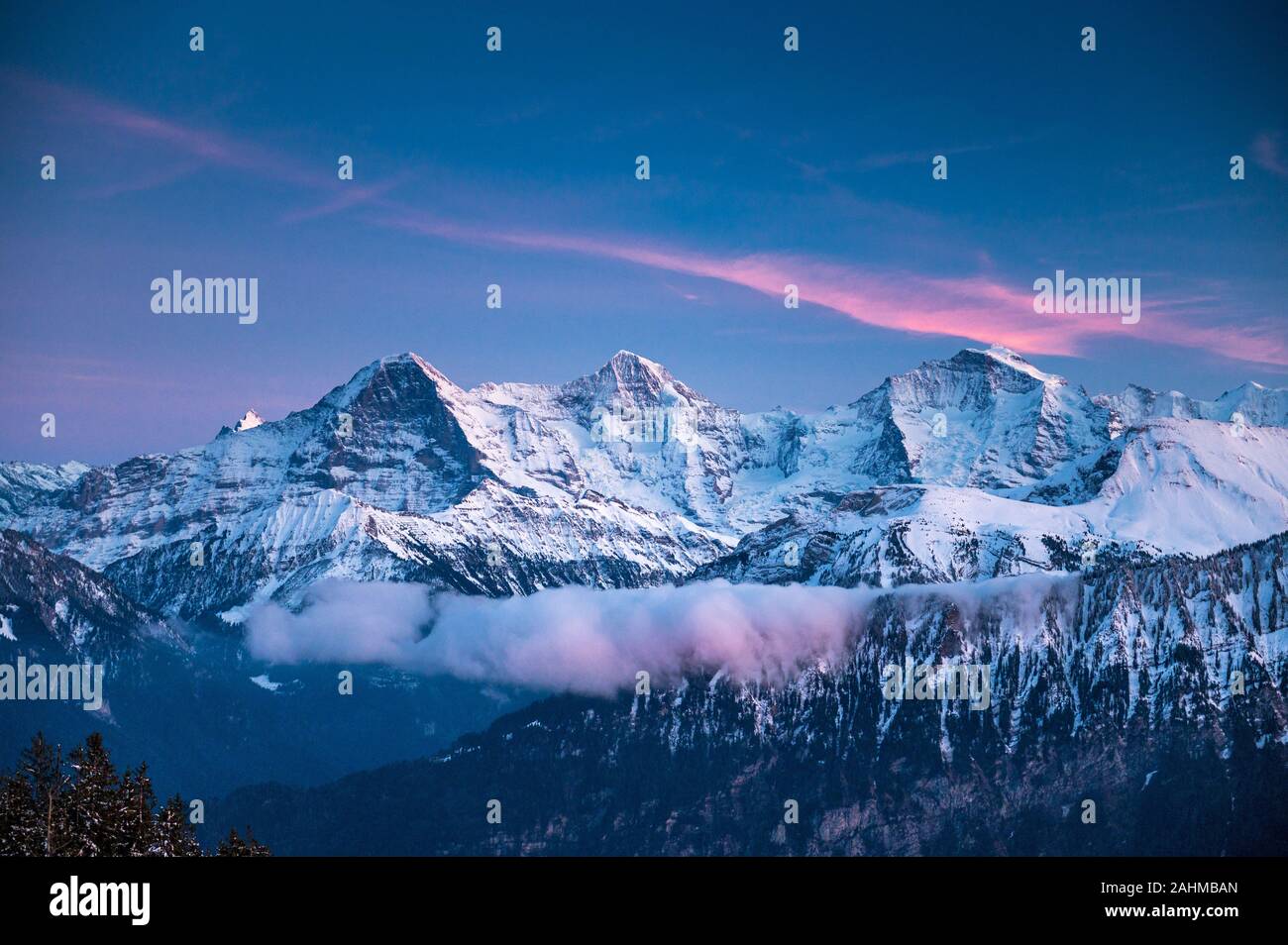 Eiger Mönch and Jungfrau during the blue hour in winter Stock Photo
