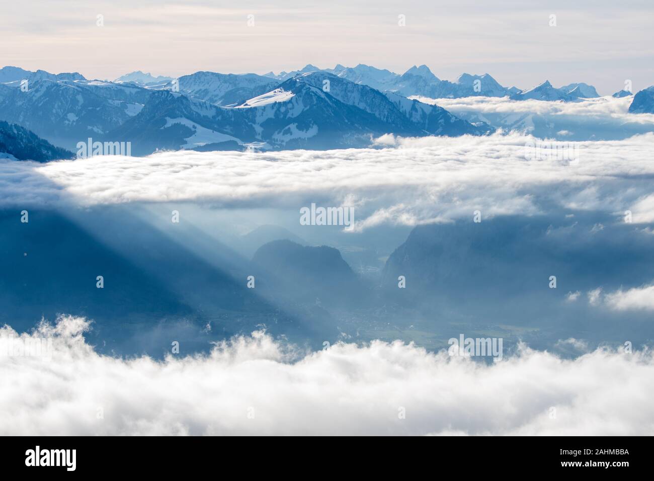 sea of clouds with sunrays at the side of Mount Niesen and Simmental Stock Photo