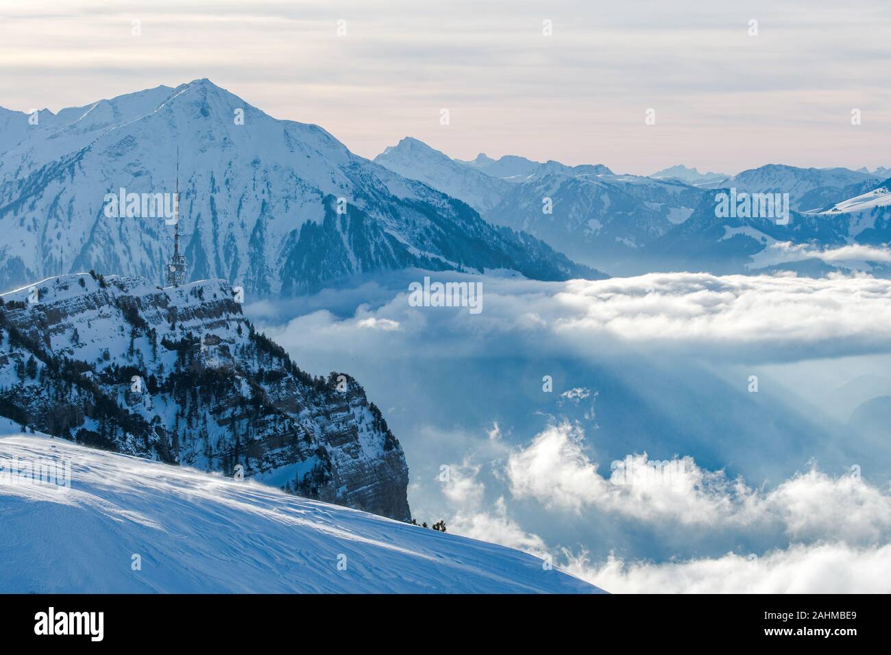 Niederhorn and Mount Niesen above a thick layer of clouds Stock Photo