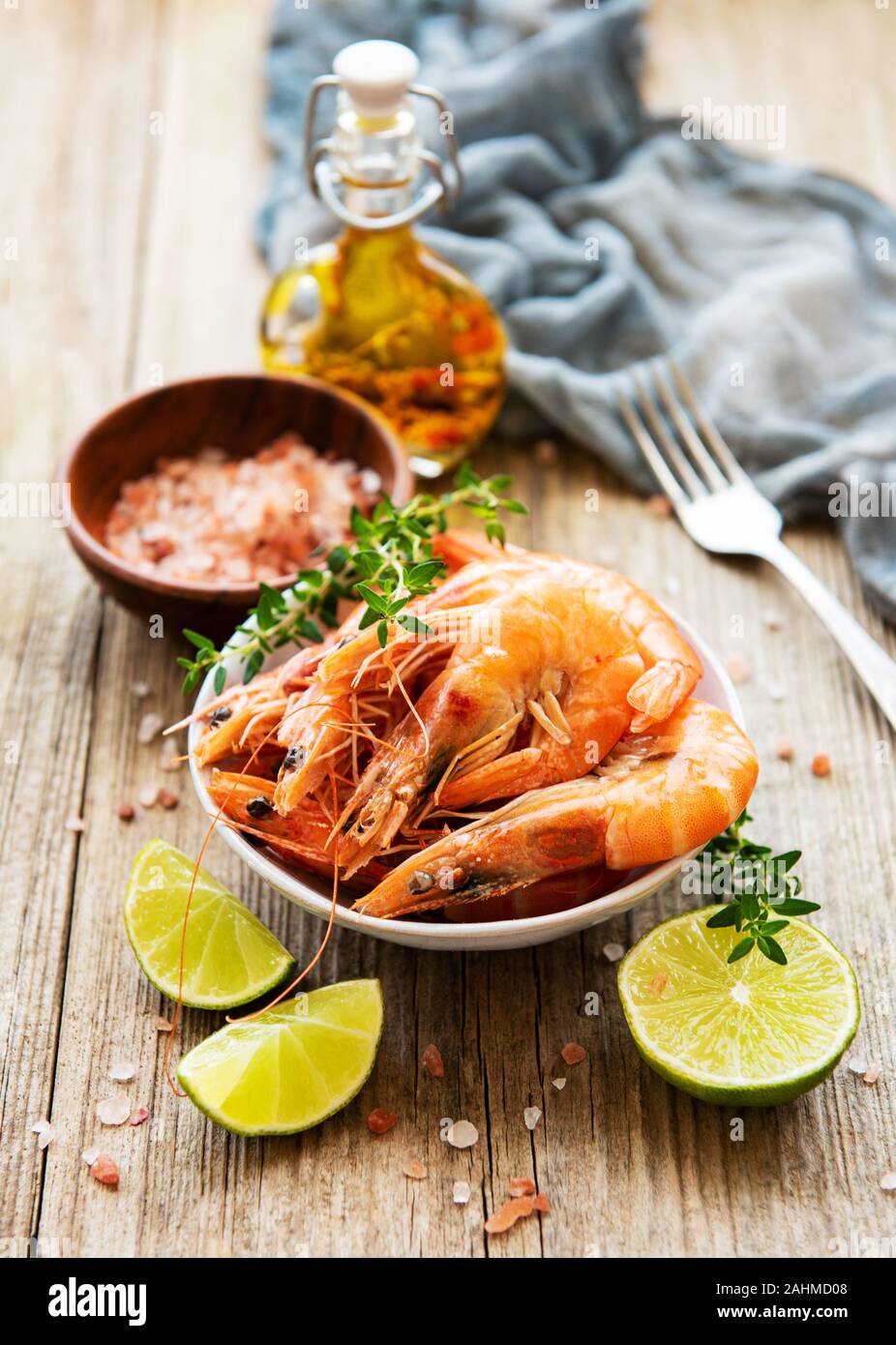 Shrimps served with lemons and spices on a old wooden table Stock Photo