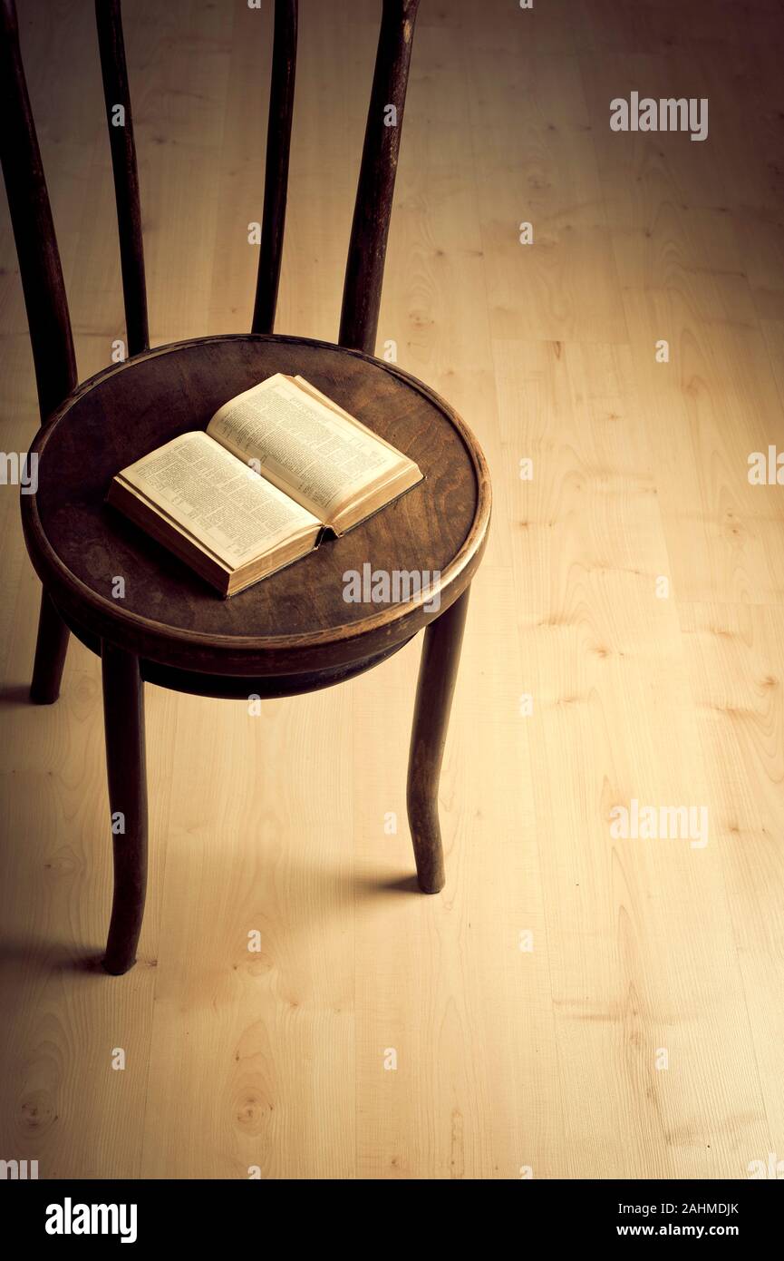 open old book on an antique chair Stock Photo