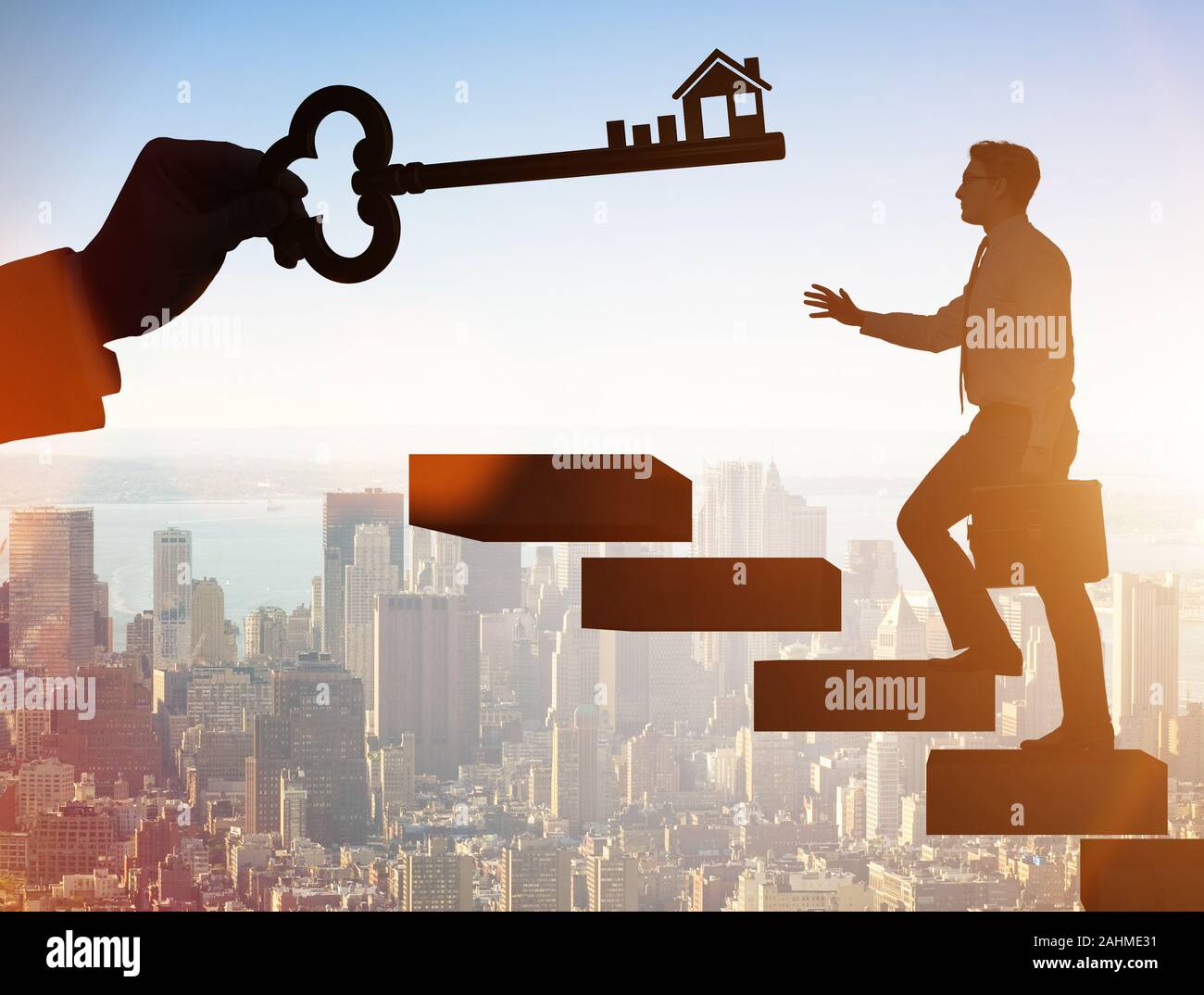 The businessman holding key in real estate concept Stock Photo - Alamy
