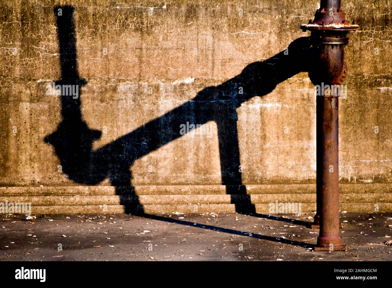 Abandoned former Victorian Era Industrial Site, Walka Water Works, cast iron water pipe casting shadow in settling pond, Maitland, Australia Stock Photo