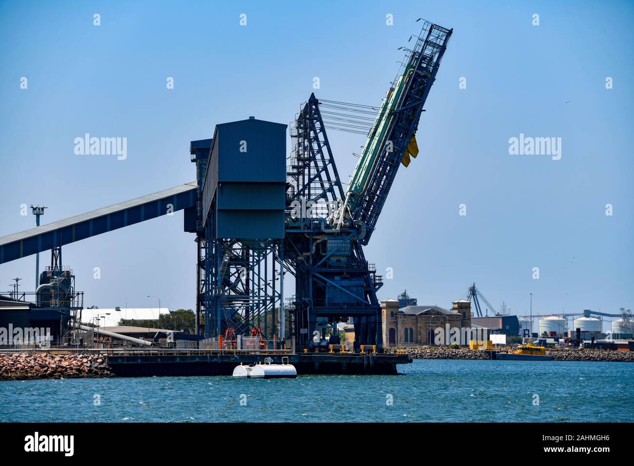 Grain Silos and Wharf Ship Loading Cranes at Port of Newcastle Stock Photo