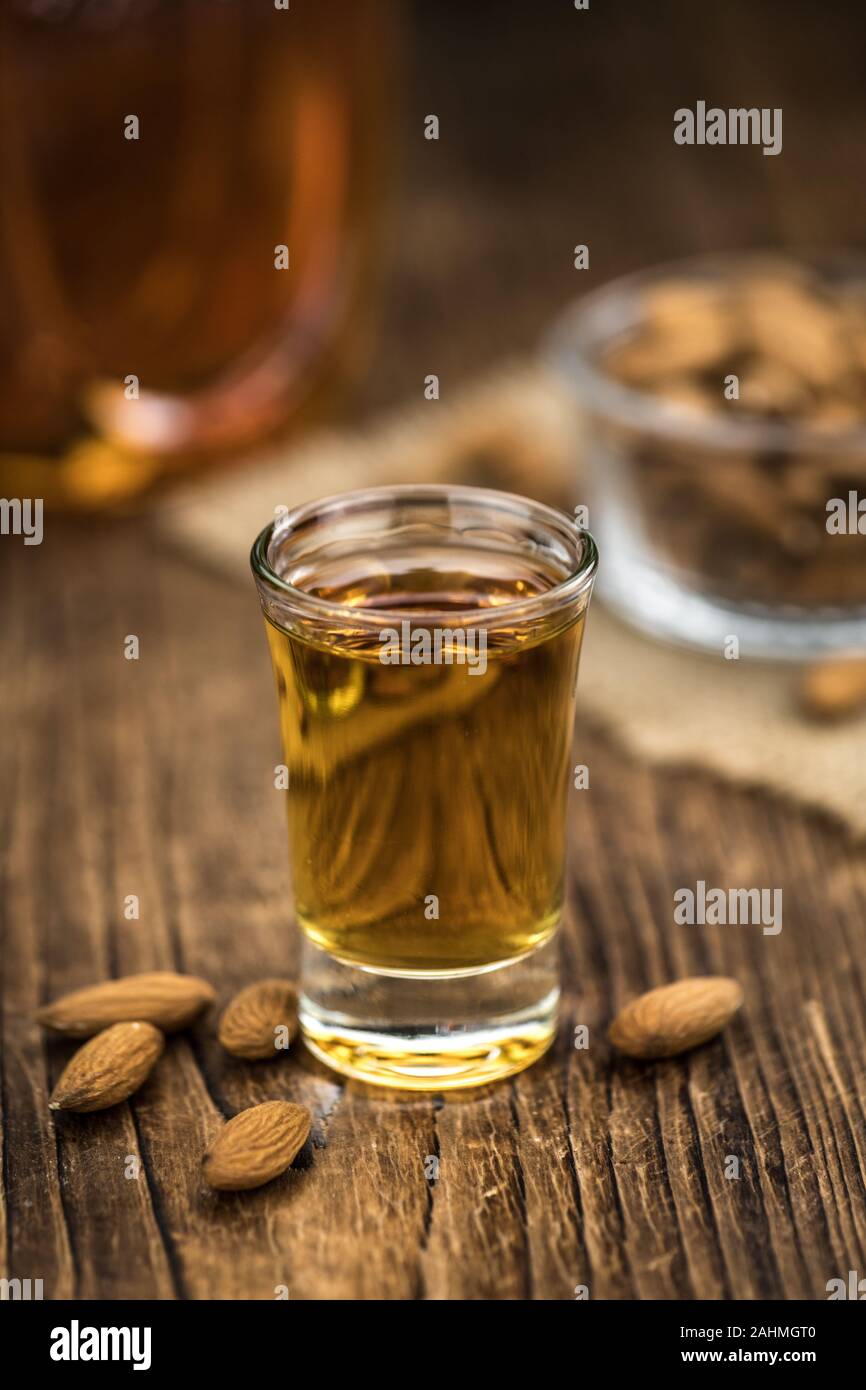 Amaretto on an old wooden table (selective focus) Stock Photo