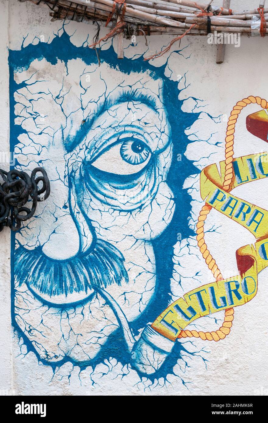 Colourful elaborate graffiti of a man's face smoking a pipe. Photographed in Nazare, Portugal Stock Photo