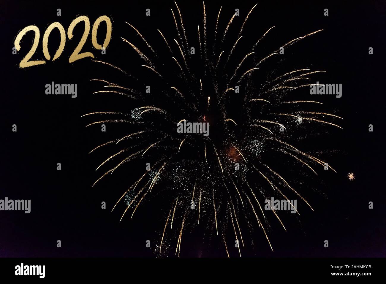 2020 Text with Festive Gold Fireworks Collage in Night Sky. Copy space ...