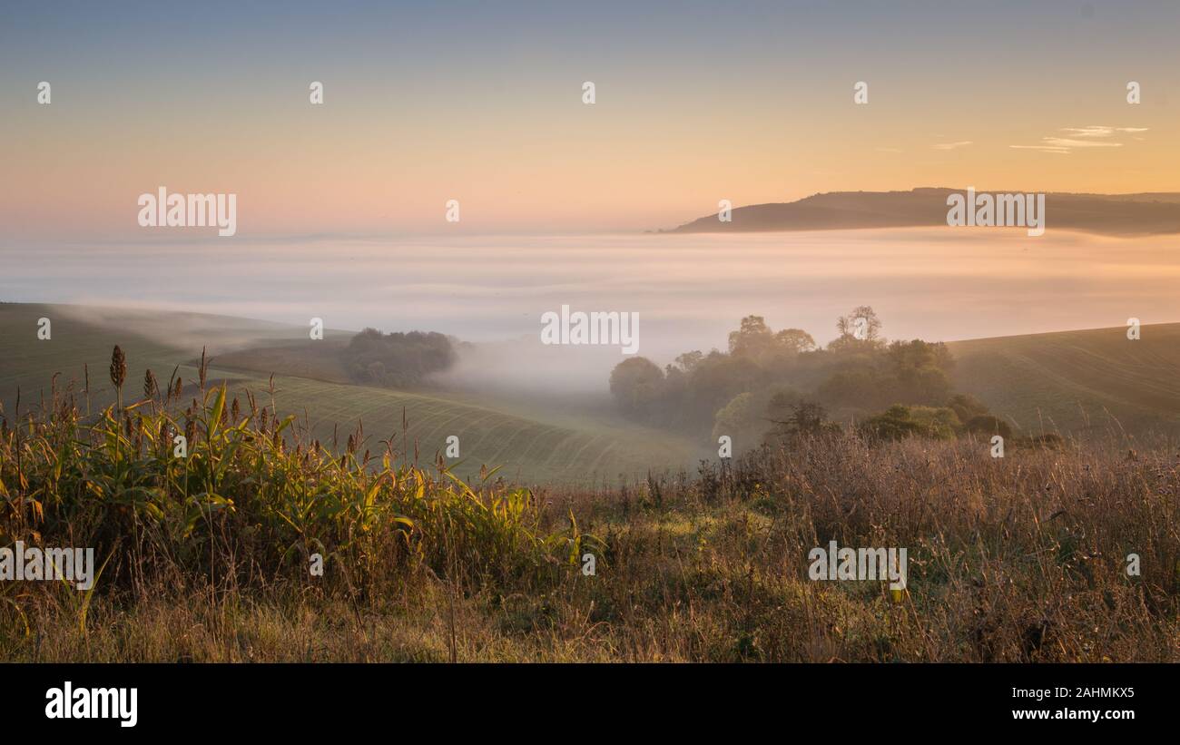 autumn sunrise and mist inversion below bury hill in west sussex Stock Photo