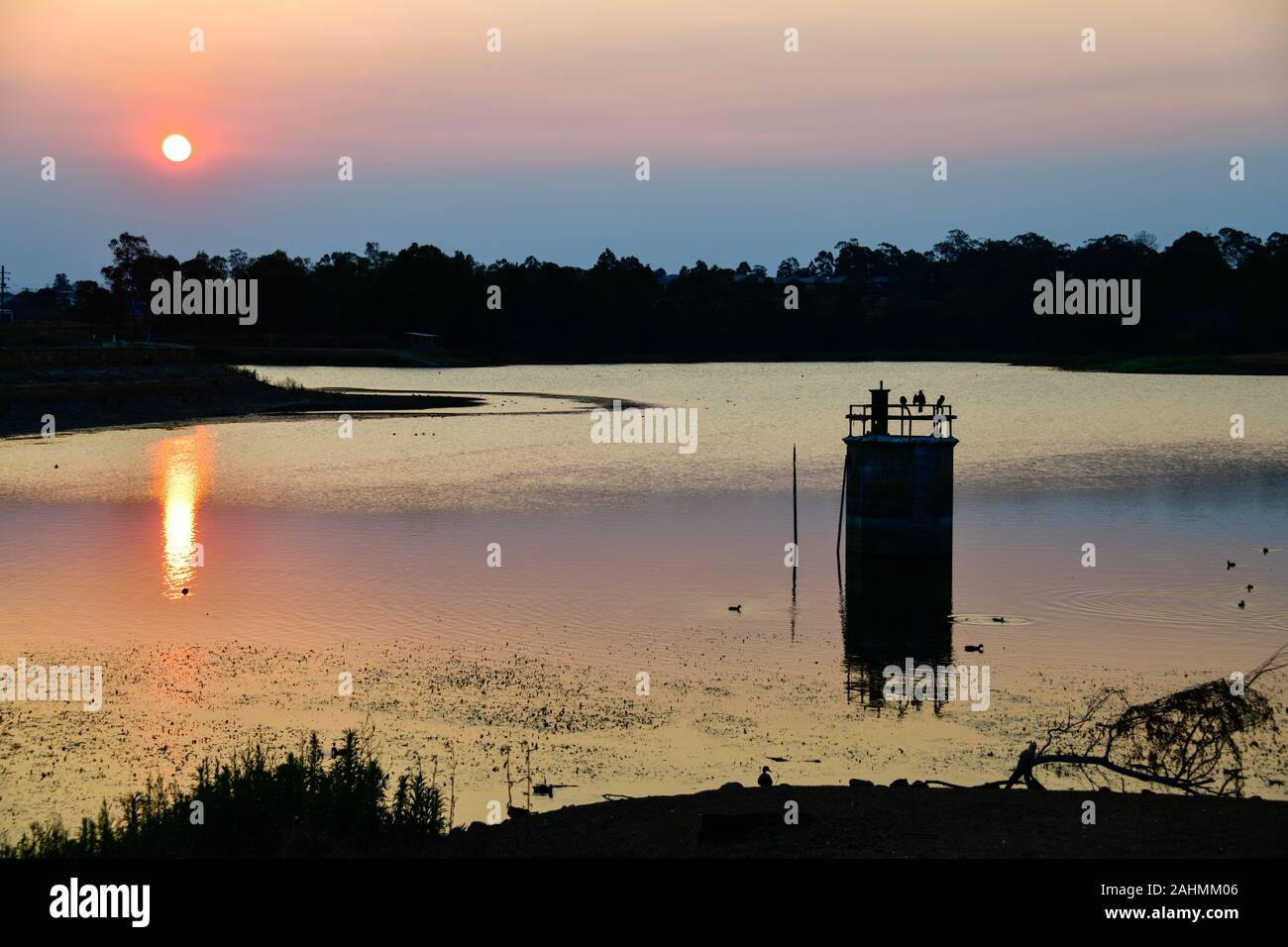 Beautiful Colourful Sunset on the Lake at 19th Century Heritage Listed former Industrial site, Walka Water Works, Maitland, Australia, with Birds Stock Photo