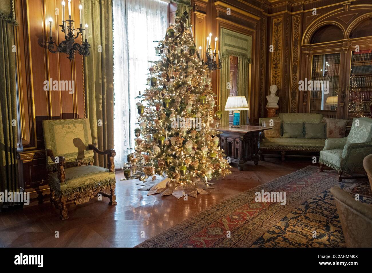 A beautifully decorated Christmas tree in the library on the second floor of the Breakers mansion in Newport, Rhode Island. Stock Photo