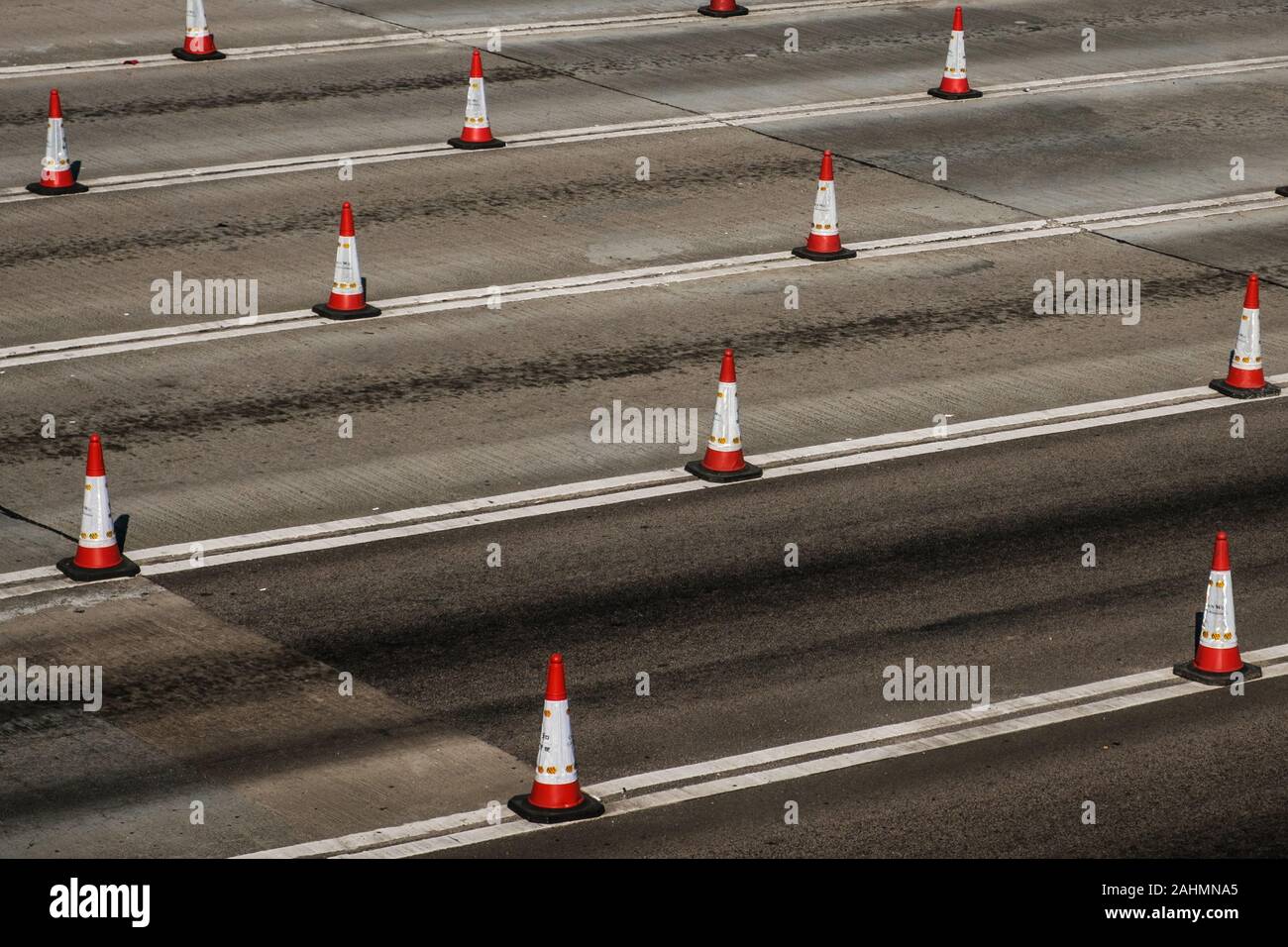 Traffic cones on multi lane highway road Stock Photo