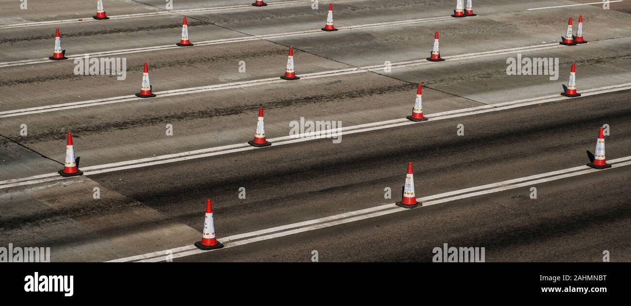 Traffic cones on multi lane highway road Stock Photo