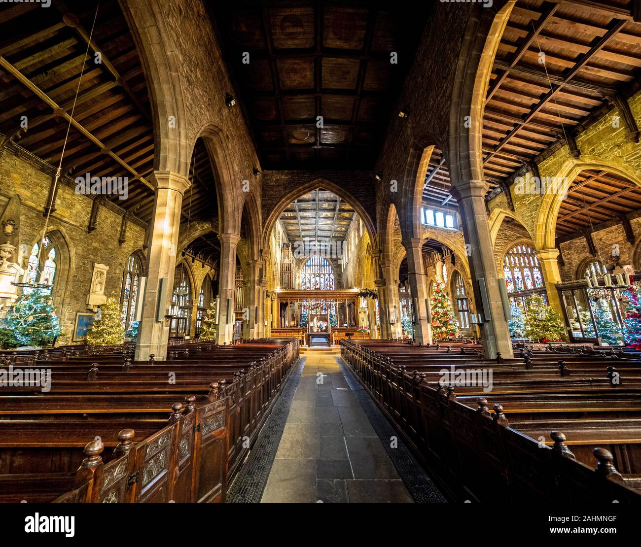 Interior of Halifax Minster at Christmas decorated with multiple
