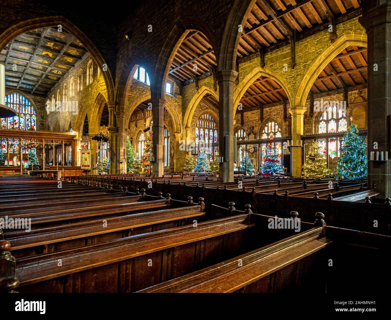 Interior of Halifax Minster at Christmas decorated with multiple
