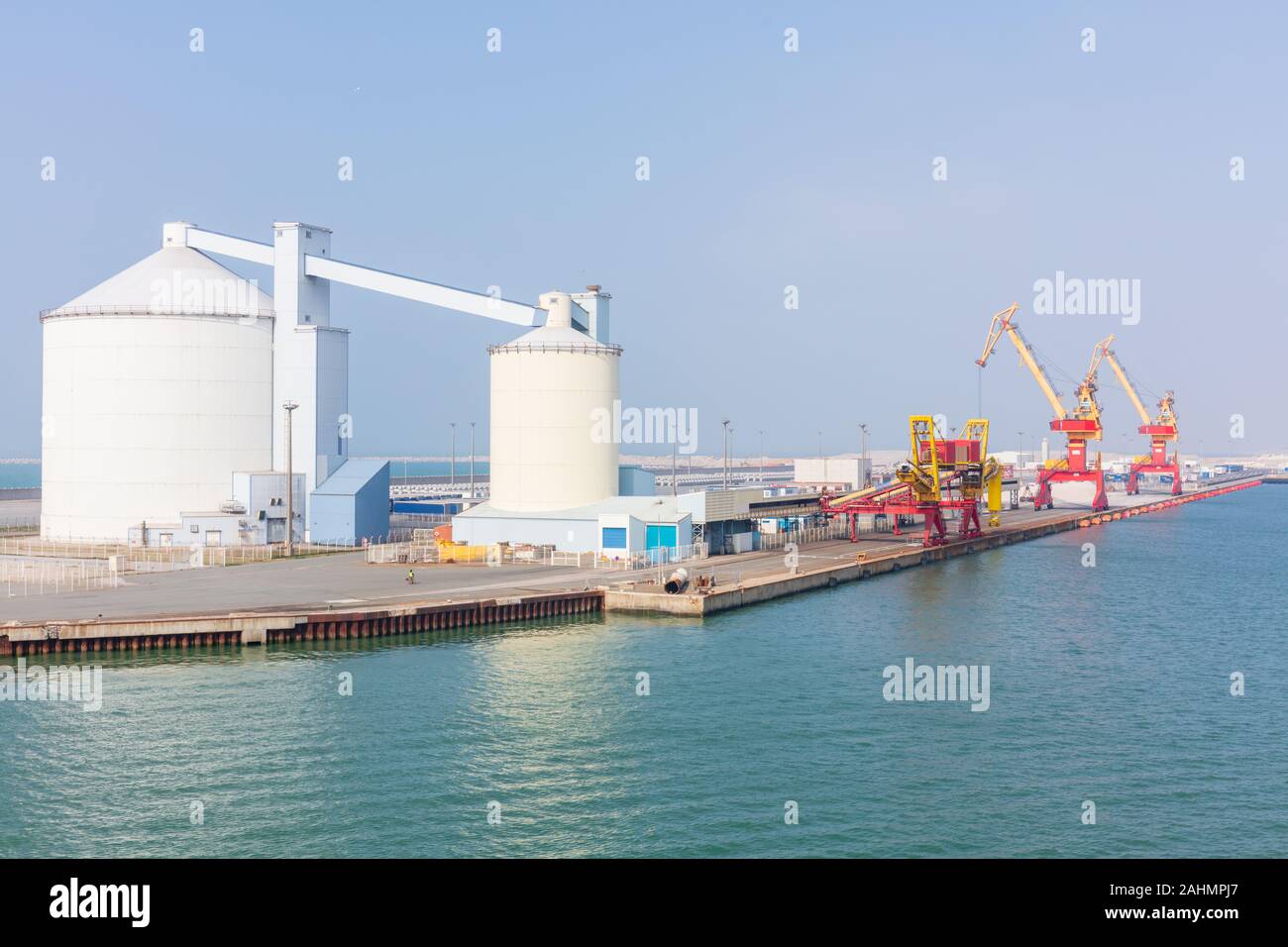 Calais, France; 20th May 2018; Storage Tanks and Brightly Coloured Cranes in the Port Stock Photo