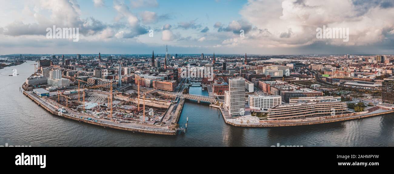 Aerial drone panoramic view of port of Hamburg from above before sunset with dramatic stormy clouds over historical city center Stock Photo