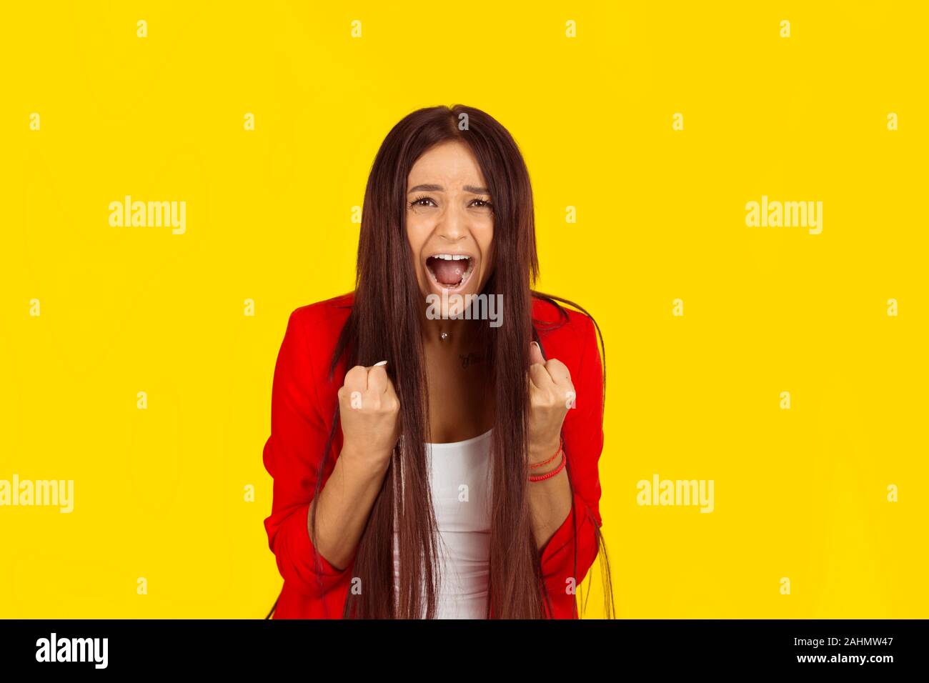 Closeup portrait angry young woman about to have nervous atomic breakdown screaming. Negative human emotion face expression feeling attitude. Mixed ra Stock Photo