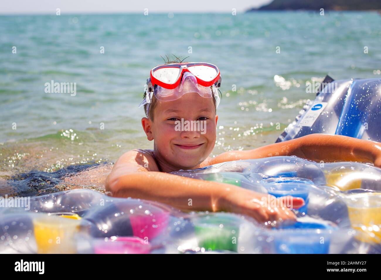 Happy little boy with air water mattress in sea, summer holiday Stock Photo