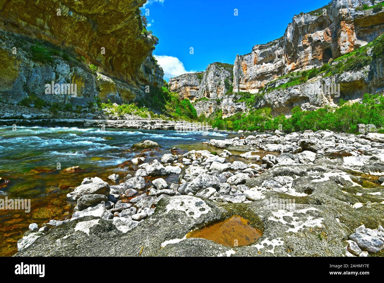 Panoramic view from the flow of Irati River dominated by walls of Lumbier Canyon, which makes a part of Sierra de Leyre mountain chain in Pyrenees of Stock Photo