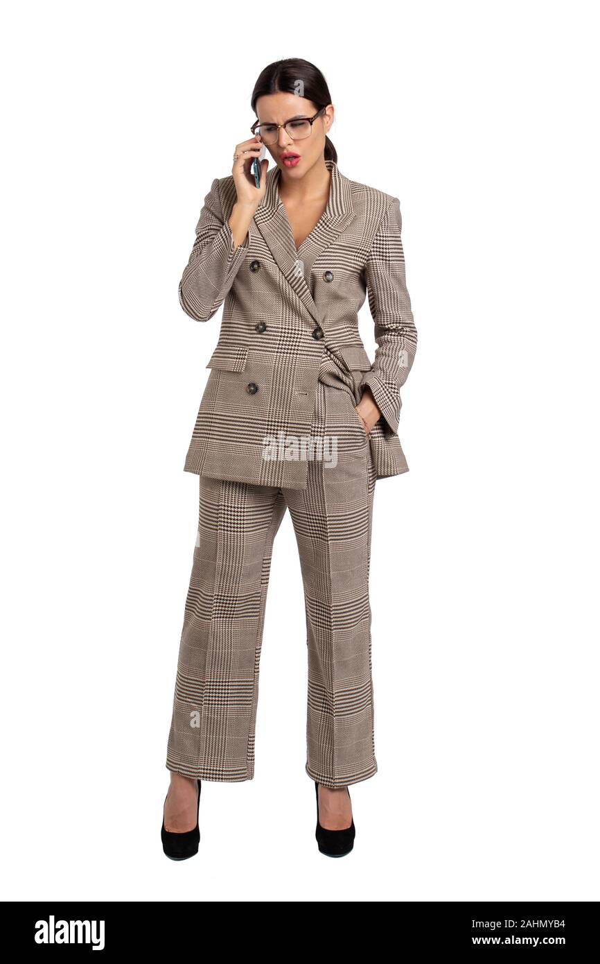 Professional young businesswoman in gray formal wear calling loudly, isolated on white, full body Stock Photo