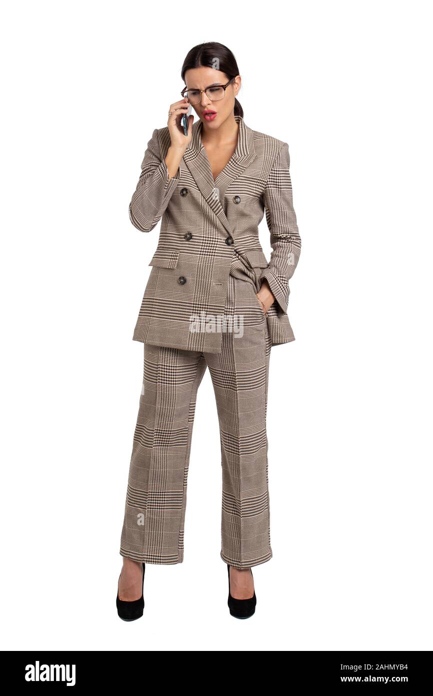 Professional young businesswoman in gray formal wear calling loudly ...